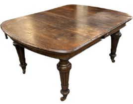 A Victorian oak extending wind-out dining table with additional leaf, top when not extended 150 x