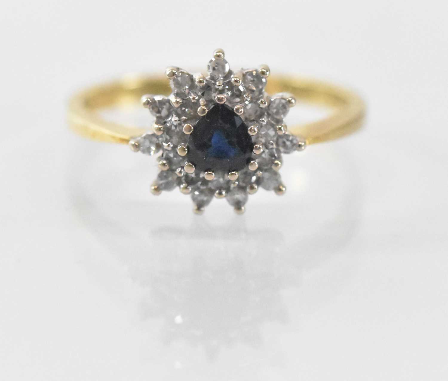 An 18ct yellow gold sapphire and diamond set cluster ring, the central heart shaped sapphire