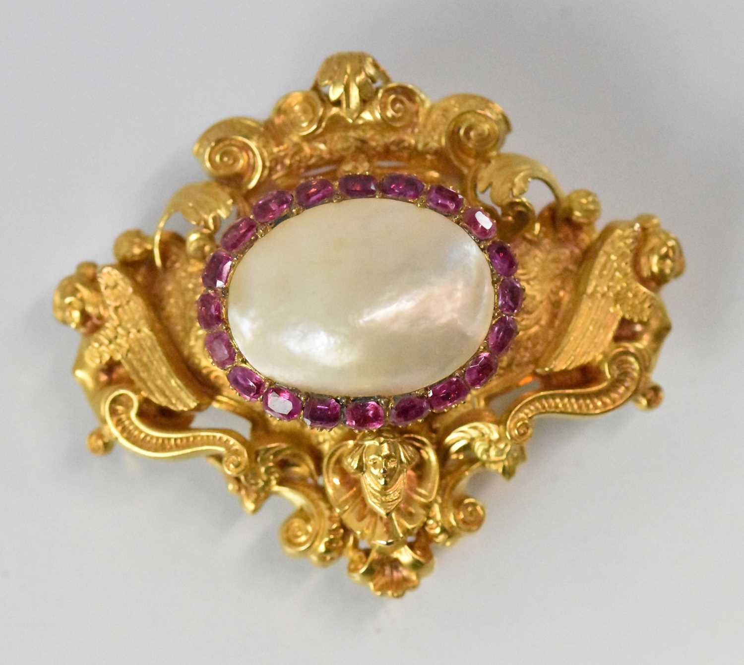 A fine Continental precious yellow metal brooch set with large central pearls surrounded by a border