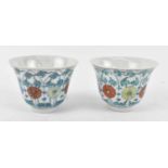 A pair of Chinese Republic period porcelain bowls, painted in enamels and decorated with lotus