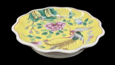 A 20th century Chinese yellow ground dish with frilled edge, the interior decorated with a bird