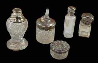 A group of four hallmarked silver topped scent bottles, one lacking stopper, height of tallest 12cm,