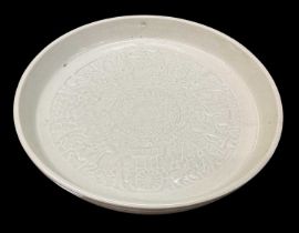 A Chinese celadon glazed dish, the interior decorated with figures, diameter 20cm.