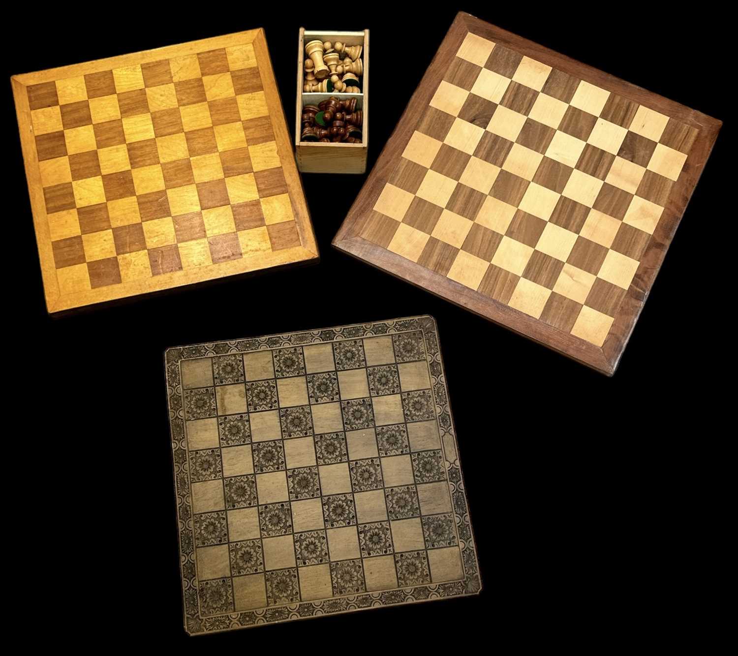 A cased set of boxwood chess pieces, height of king 9.5cm, with three chessboards.