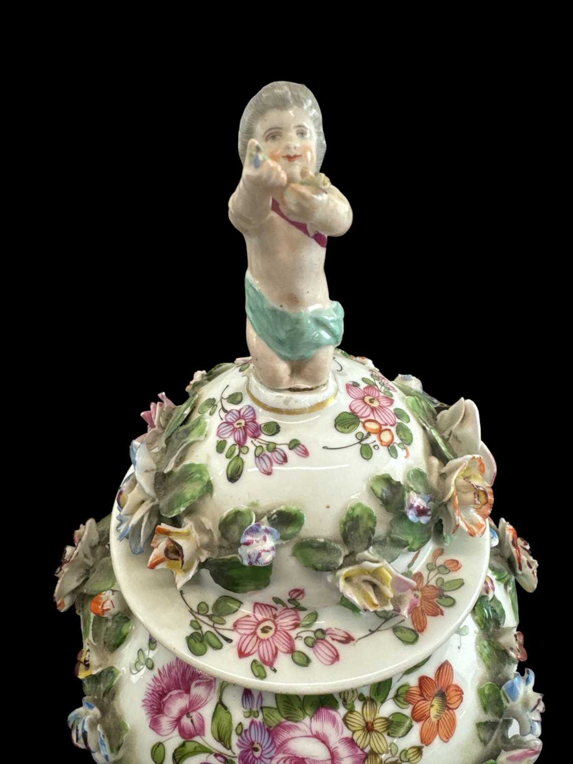 A pair of 19th century Continental floral encrusted and hand painted lidded urns with cherub - Image 3 of 3