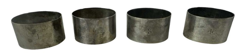 WILLIAM HUTTON & SONS LTD; a cased set of four Victorian hallmarked silver napkin rings numbered 1 -