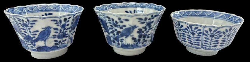 A pair of Chinese blue and white porcelain tea bowls decorated with birds amongst foliage and