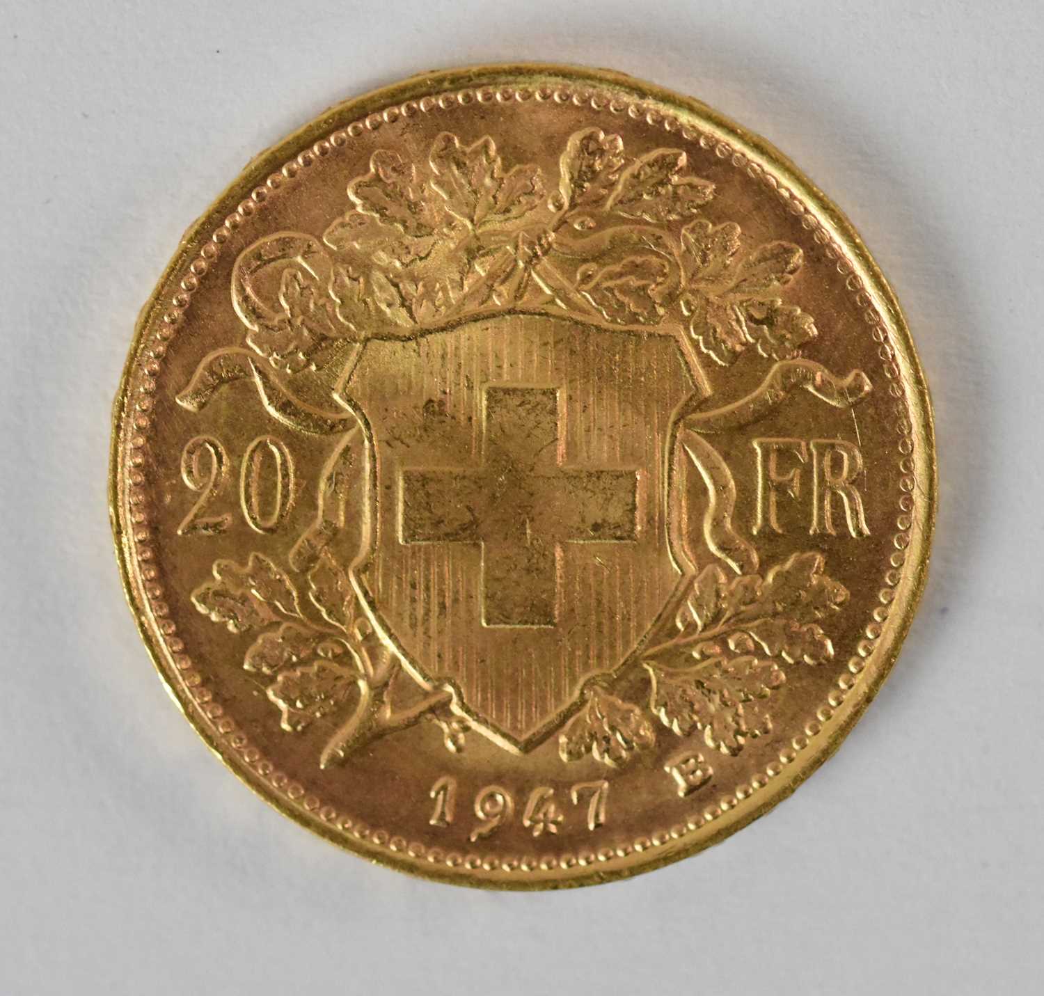 A 1947 Swiss franc gold coin, diameter 2cm, approx 6.5g.