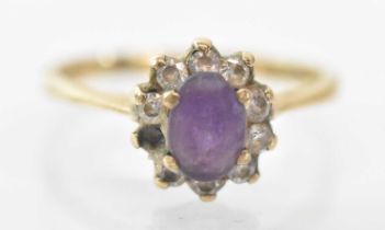 A 9ct yellow gold amethyst set ring, the central amethyst approx 0.75ct, surrounded by nine diamonds