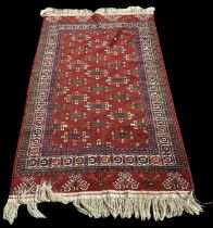 A modern red ground Turkmenistan Yamout hand knotted wool pile rug, 187 x 114cm. Provenance: This