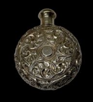 A Continental white metal scent bottle, the body of circular form, with carved floral decoration,