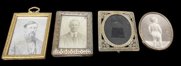 A decorative white metal rectangular photograph frame, 11 x 8.5cm, with three further decorative