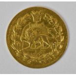 A small Persian/Iranian gold coin with a lion to the front, diameter 1.7cm, approx 1.5g.