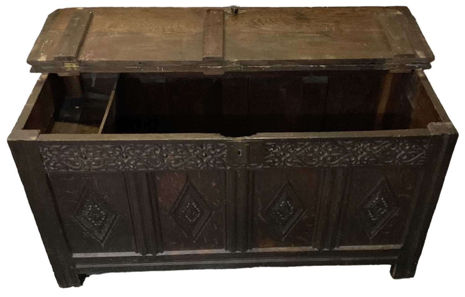 An 18th century carved oak coffer, with hinged lid and candle holder, width 142cm. - Image 2 of 2