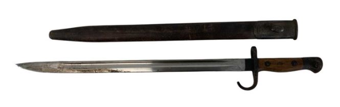 A WWI Wilkinson Sword bayonet, with scabbard, length 57.5cm.