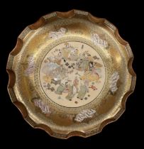 A late 19th century Japanese Satsuma ware dish, with wavy rim and decorated with figures, diameter