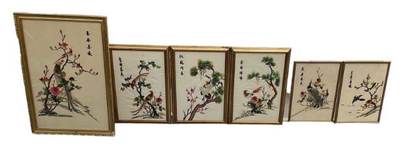 A modern Chinese embroidery of a bird amongst foliage, four character mark upper right, 57.5 x 37cm,