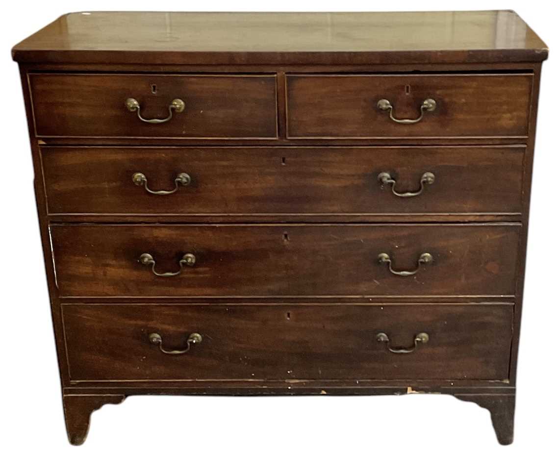 A 19th century mahogany chest of two short over three long drawers with brass handles, on bracket