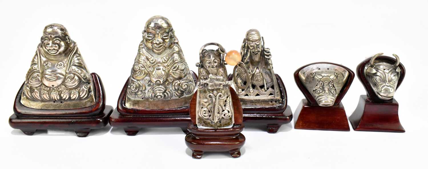 Three pairs of Mongolian white metal hat finials, each now mounted on a modern wooden stand for