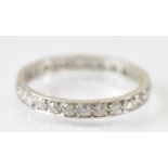 A white metal diamond set eternity ring, size R/S, approx 3.6g.