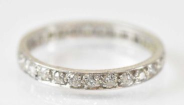 A white metal diamond set eternity ring, size R/S, approx 3.6g.