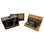 Two cased Singer sewing machines.