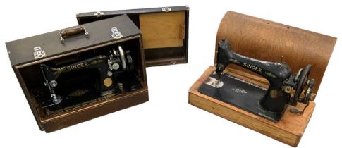 Two cased Singer sewing machines.