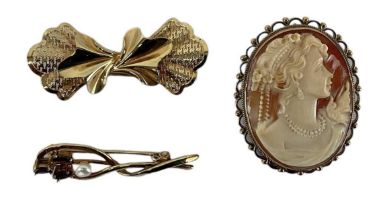 A 9ct yellow gold mounted cameo brooch, a 9ct yellow gold brooch and a further 9ct yellow gold red