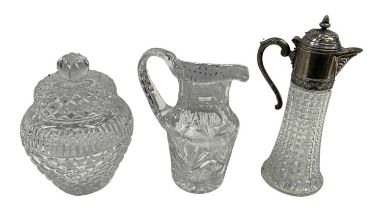 A cut glass pewter mounted claret jug, height 30cm, a cut glass lidded biscuit barrel, height