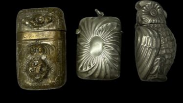 A pewter vesta case modelled as an owl, with hinged lid, height 5.5cm, a silver plated vesta case,