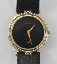 GUCCI; a gentleman's wristwatch with black dial, diameter excluding winding crown 2.5cm, on black