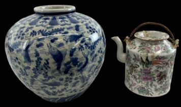 A 19th century Chinese Famille Rose porcelain lidded teapot with swing loop handles, height 14cm,