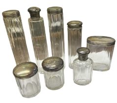 CHARLES FOX & CO LTD; a group of five hallmarked silver topped dressing table jars, the tallest