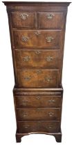 A reproduction narrow chest on chest, with two short above three long drawers, pull-out slide and