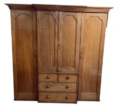A large late 19th century mahogany breakfront wardrobe, with pair of cupboard doors above two
