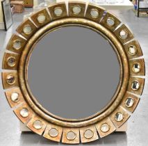 A modern circular wall mirror, the frame set with multiple circular mirrored panels, diameter
