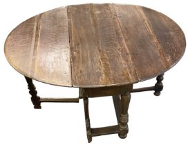 An 18th century oak drop-leaf gateleg table with single drawer, width 102cm.