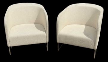 A pair of modern stylish yellow upholstered armchairs on chrome supports.