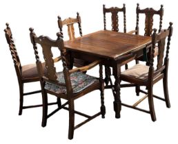 A 1920s oak draw-leaf dining table on barley twist supports, with six chairs (4+2).
