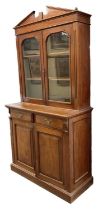 A Victorian mahogany bookcase, with pair of glazed doors enclosing two shelves above two drawers
