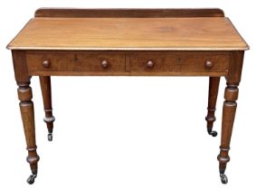 A Victorian mahogany two drawer writing table, on turned supports, width 108cm.