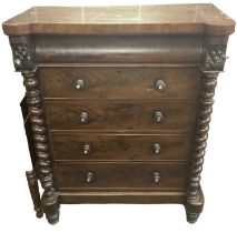 A 19th century mahogany chest of four long drawers, with barley twist columns and carved decoration,