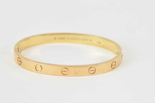 CARTIER; an 18ct gold hinged LOVE bracelet with screw motifs, marked to the inside 'Cartier 17 - Image 3 of 9