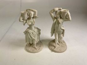 A pair of Parian ware figures, possibly depicting Jack and Jill with their pails for water, height