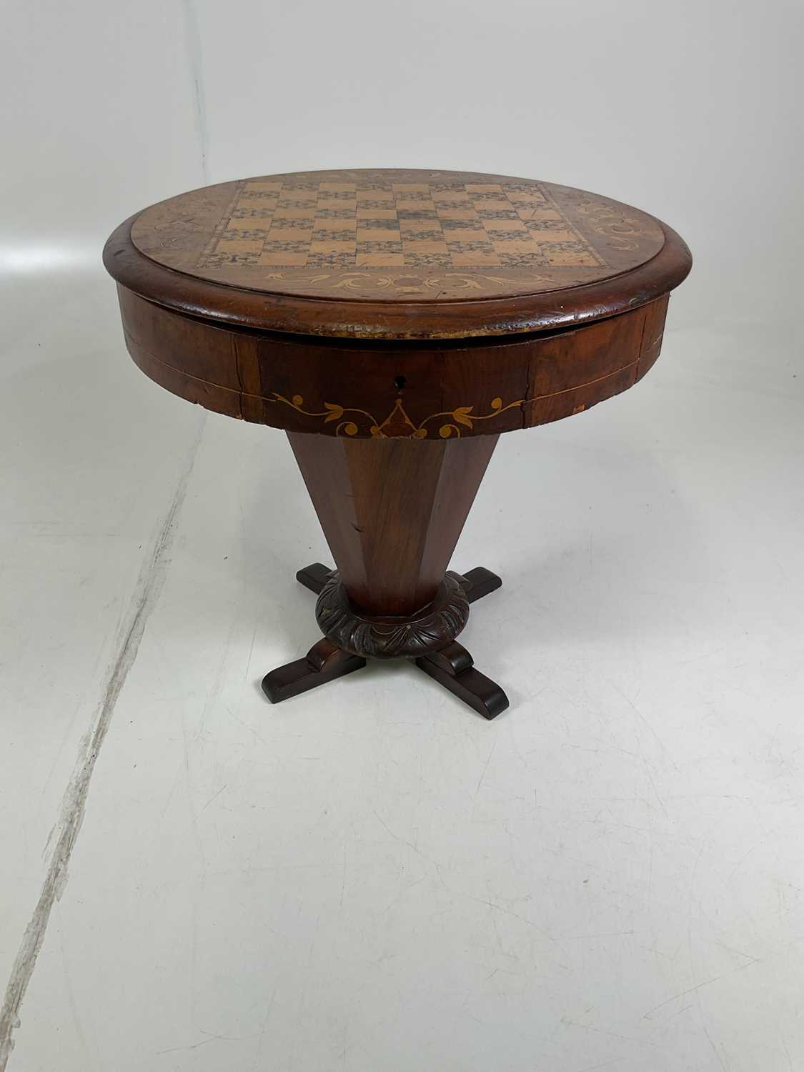 A trumpet sewing table, height 44 cm, diameter 47cm, incorporating a chessboard inlaid on top.
