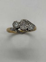 An 18ct yellow gold and platinum tipped three stone diamond ring, approx 0.80ct, size K, approx 2.