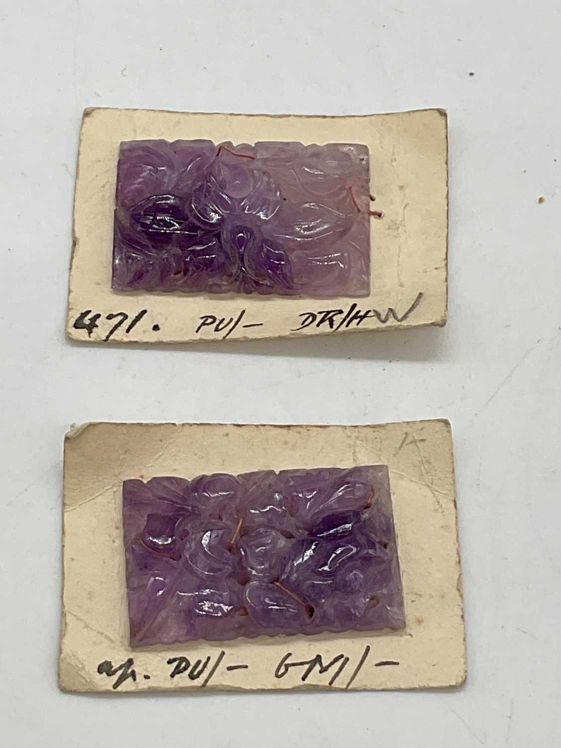 An unusual pair of floral carved amethyst plaques mounted on card, 34 x 22mm.