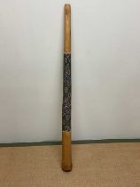 A vintage Australian didgeridoo with Aboriginal hand painted detail depicting a snake, length