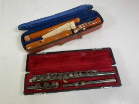 Two musical instruments including a flute and a Yamaha recorder, both cased.