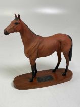 BESWICK; Red Rum mounted on an oval wooden base, height 32cm.